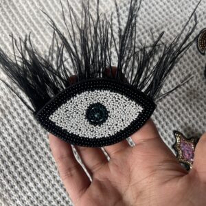 Evil eye with black feathers