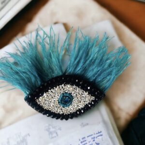 Evil eye with feather brooch
