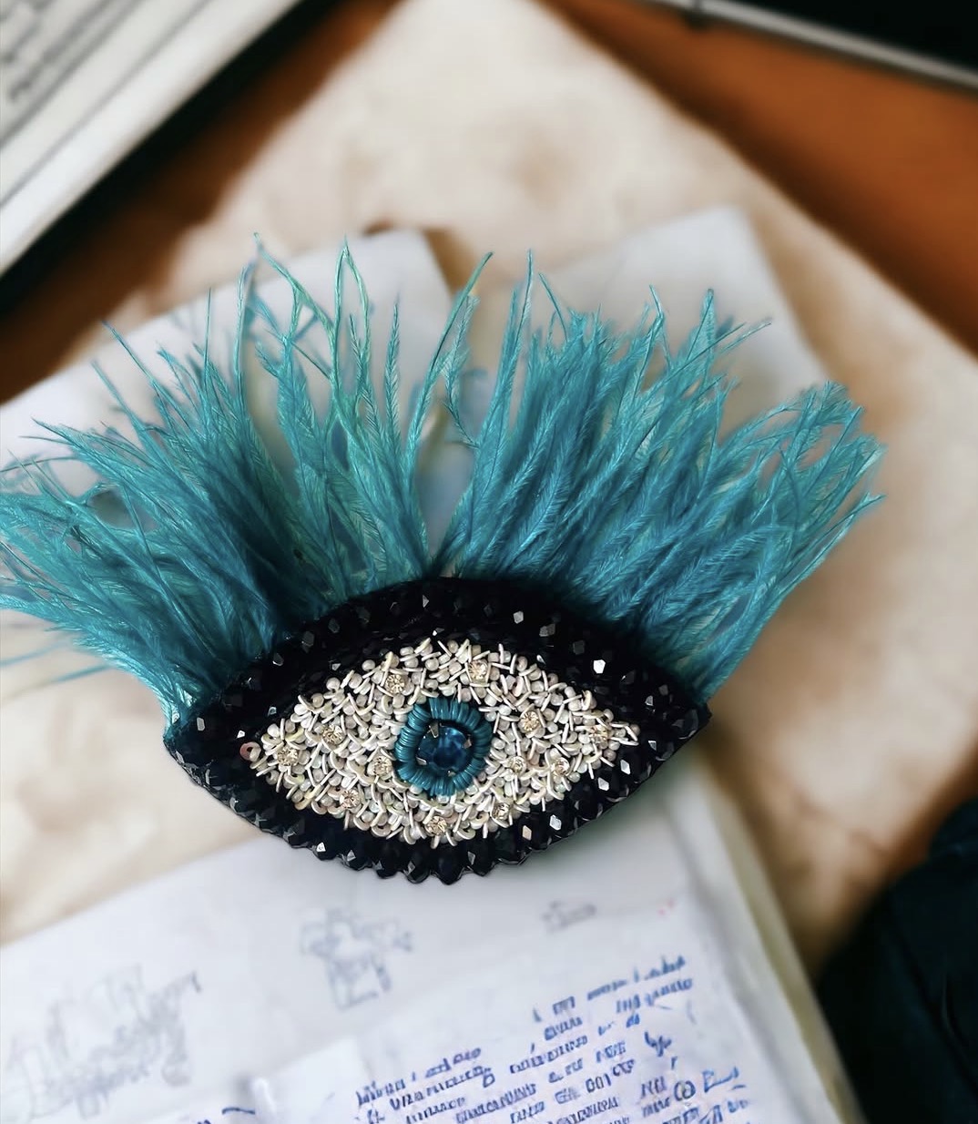 Evil eye with feather brooch