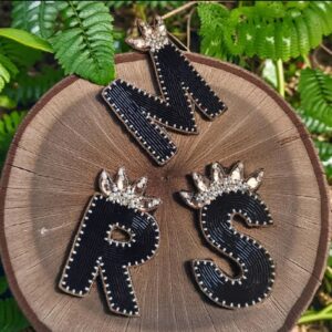 Black initial brooch